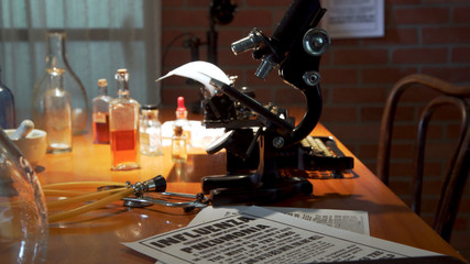 Scene tracks around a quiet laboratory setting from 1918 when the Spanish influenza virus was at pandemic proportions.