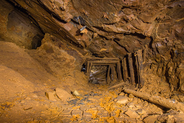 Abandoned underground bauxite mine tunnel with ore pillar