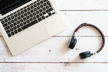 Home office notebook and headset on white wood