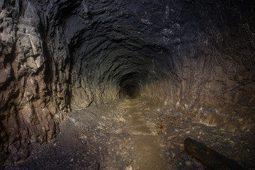 Underground abandoned bauxite ore mine tunnel - obrazy, fototapety, plakaty