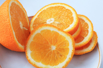 Orange oranges sliced in circles on a white background.