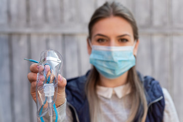 Woman holding oxygen mask outside