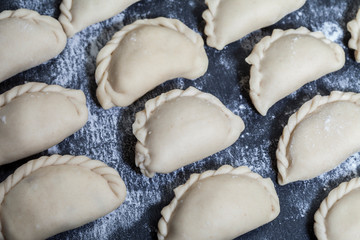 Raw dumpling with potatoes. Preparation dumplings on a wooden board.