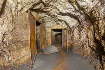 Underground abandoned bauxite ore mine tunnel with doors
