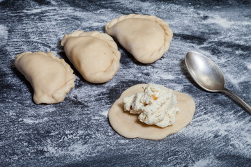 Raw dumpling with potatoes. Preparation dumplings on a wooden board.