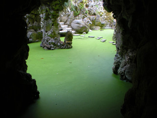view from the cave to a green lake