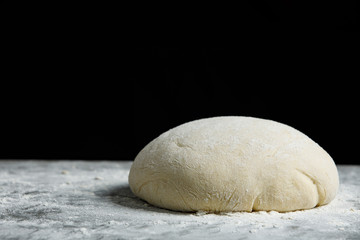 Fototapeta na wymiar Sourdough bread proving on black background