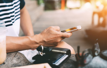 Young man sitting using smartphone while travelling outside, Outgoing smart working