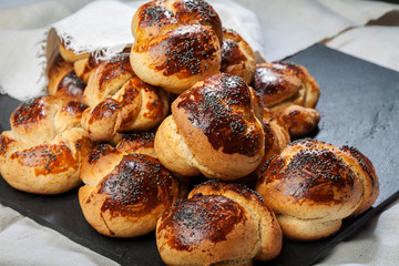 Bun with poppy seeds. Butter bun with poppy seeds on a linen napkin