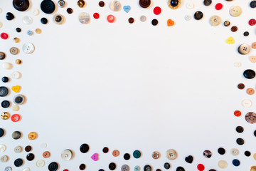 Composition of multiple colorful buttons spreaded in white background. Copy space, flat lay