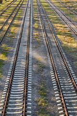 Rusty railroad tracks on gravel. Top view.