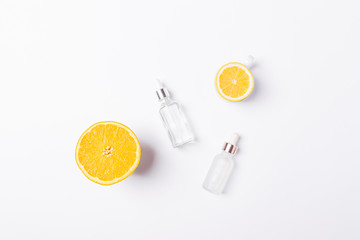 Bottles of cosmetic serum with vitamin C