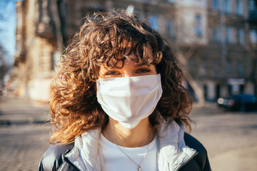 Portrait young woman in white medical protective face mask