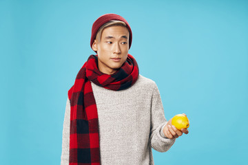 young man holding an apple