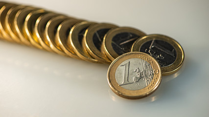 One euro coin on the background of a lying stack of euros.  Web banner.