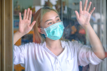 Young woman in medical mask stay isolation at home for self quarantine. Concept home quarantine, prevention COVID-19, Coronavirus outbreak situation.