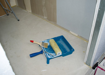 Set of tools for the painter and redecoration on a concrete floor.