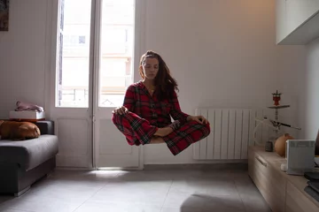 Fotobehang Young woman yogi levitation and meditation concept. © Frenchiebuddha