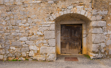 An old wooden door in a derelict building in the historic hill village of Stanjel in the Komen municipality of Primorska, south west Slovenia.
