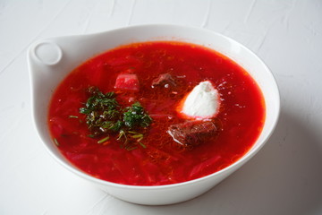 Traditional Ukrainian Russian borscht . Bowl of red beet root soup borsch with white cream . Beet Root delicious soup . Traditional Ukrain food cuisine 