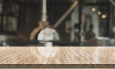 Wooden top table with bokeh light effect and blur restaurant on background, blur background