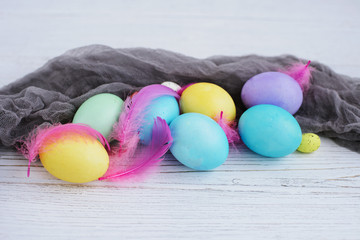 colored Easter eggs on a white wooden background. place for text