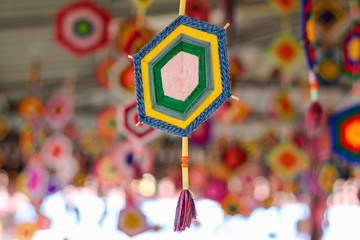 The amulet is made of yarn by binding and weaving into a shape as a symbol of faith in order to...