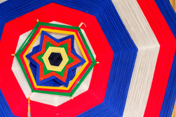 The amulet is made of yarn by binding and weaving into a shape as a symbol of faith in order to...