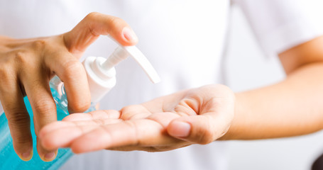 woman applying pump dispenser sanitizer alcohol gel