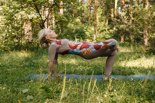 Healthy life exercise concept - Woman doing Hatha yoga asana ardha purvottanasana (Reverse Table Pose). plank pose outdoors