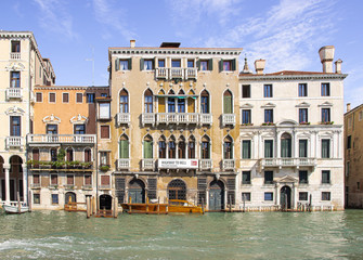 Fototapeta premium Water channels of Venice city. Facades of residential buildings overlooking the Grand Canal in Venice, Italy.