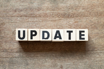 Fototapeta premium Letter block in word update on wood background