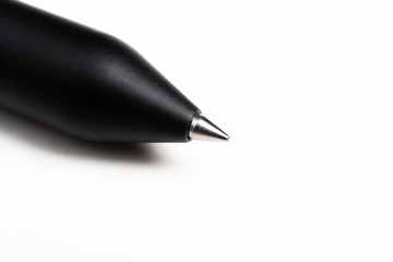 A macro shot of the writing tip with a portion of the barrel of a streamlined modern black...