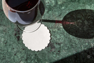coaster for wine chalice on green marble - obrazy, fototapety, plakaty
