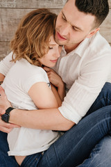 Fototapeta premium Young couple portrait. Beautiful pretty woman hugging handsome man. Sensual photo