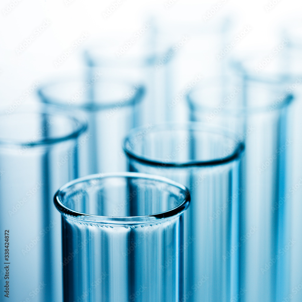 Wall mural different laboratory glassware with liquid and with reflection