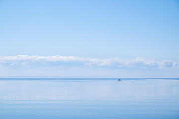 Blue lake with straight horizon and boat