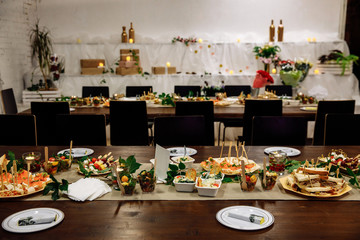 Banquet hall in the restaurant. Concept: Serving. Celebration. Anniversary. Wedding. Numbered table. A variety of salads and snacks