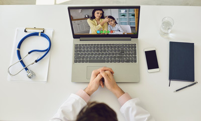 Online call pediatrician. Doctor online. Therapist consults a family mother and her daughter using...