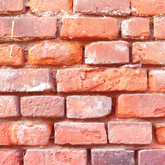 Obraz premium Red brick wall with cracks and scratches. Old background texture. Vintage house facade.