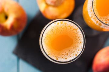 Bellini champagne cocktail in crystal glass on blue wooden table. Top view	