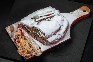 Christmas stollen with candied fruit and raisins on a festive table