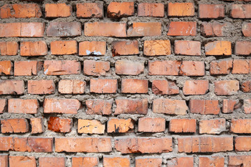 Weathered red brick wall texture and grey cement. Seamless texture background for exterior of building