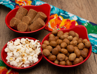 several bowls full of peanuts  and popcorn on the table