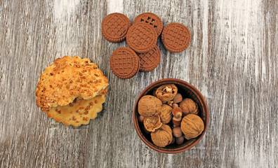 Chocolate and shortbread biscuits and a plate of rustic with nuts