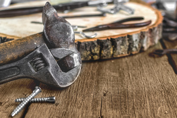 A set of metal tools in the workshop on an old rustic wooden background.concept.Father's day or labor day holiday.A greeting card or banner for your store or website.