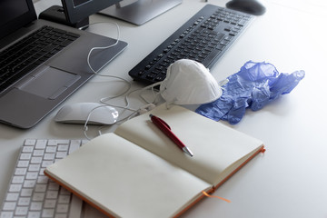 Medical mask and gloves on the desktop. Remote work and study. Notepad with place for text and pen for notes. Layout. Desktop, workspace for working at home