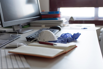 Medical mask and gloves on the desktop. Remote work and study. Desktop, workspace for working at home. Office background