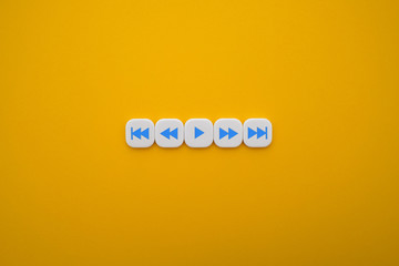 a set of music play buttons in a yellow background