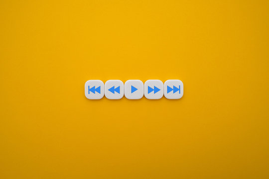a set of music play buttons in a yellow background